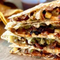 Quesadilla Al Pastor · Mexican cheese blend, al pastor pork Shoulder, roasted poblano pepper, grilled pineapple pic...