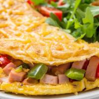 The Mess Omelette · Delicious ham, crispy bacon, sausage, onions and peppers all mixed with home fries topped wi...