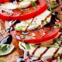 Caprese Salad · Roma tomatoes, fresh mozzarella, basil, extra virgin olive oil, and balsamic reduction.