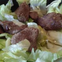 Steak Tip Salad · Marinated top-grade sirloin steak tips, grilled mushrooms, peppers & red onions served on a ...