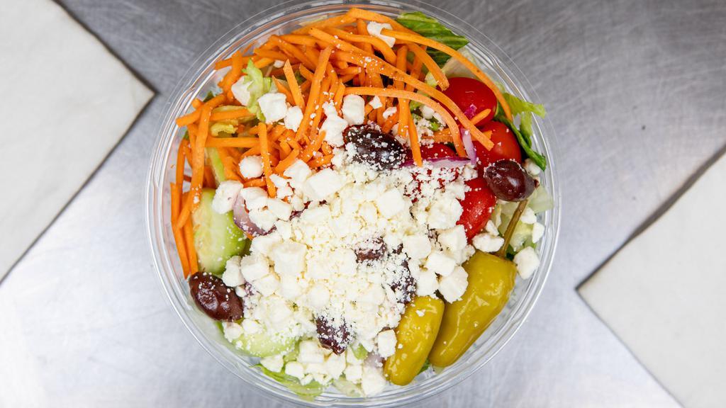 Greek Salad · lettuce, tomatoes, red onion, carrots, peppers, cucumbers, pepperoncini, feta, and Greek olives.