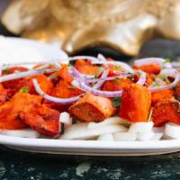 Tandoori Tikka · Broiled cubes of chicken marinated in yogurt and spices.  Served with basmati rice.