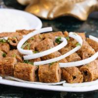 Seekh Kebab · Minced lamb seasoned with onions and herbs, then barbecued.  Served with basmati rice.