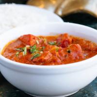 Chicken Tikka Masala · Chicken cubes cooked with onions and peppers in a tomato and butter sauce.  Served with basm...