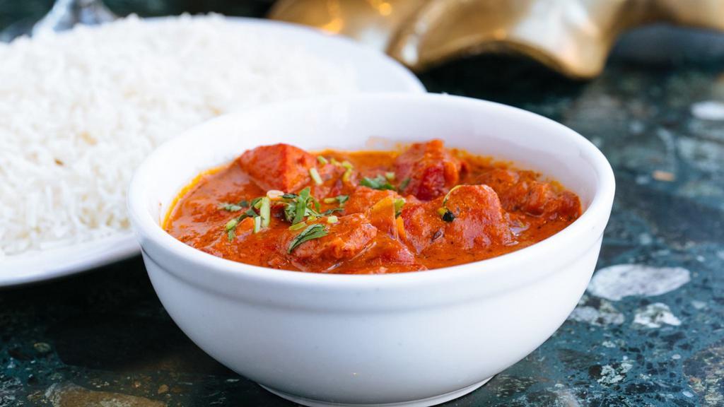 Chicken Tikka Masala · Chicken cubes cooked with onions and peppers in a tomato and butter sauce.  Served with basmati rice.