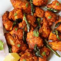 Chicken 65 · Slightly battered fried chicken marinated in yogurt, spices and stir-fried with onions and c...