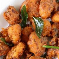 Gobi 65 · Slightly battered fried cauliflower marinated in yogurt, spices and stir-fried with onions a...