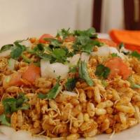 Bhel Puri · Puffed rice crisps, potatoes, onions, tomatoes, and chutney.