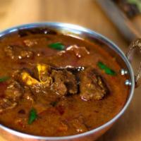 Goat Curry · Goat prepared in a mildly spiced sauce.