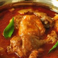 Chicken Curry · Chicken cooked with tomato, onion sauce, and spices.