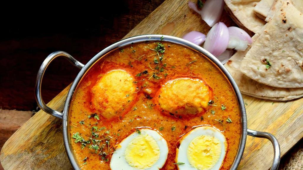 Egg Curry · Boiled eggs cooked with tomatoes, onions, and spices.