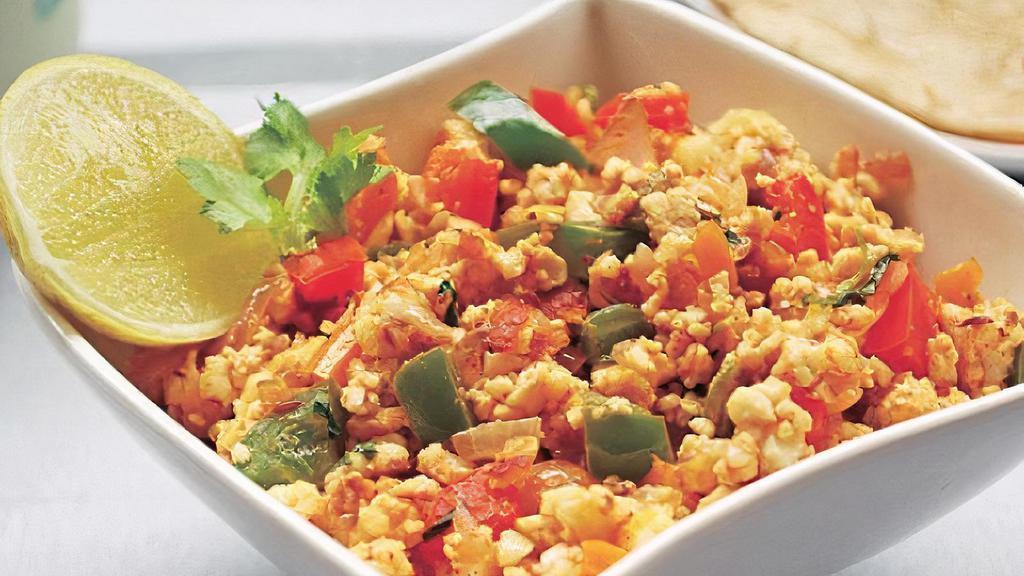 Egg Burji · Scrambled eggs gently cooked with tomatoes, onions and bell peppers with Indian spice.