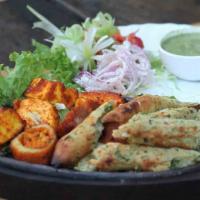 Mixed Tandoori Sizzler · Combination of seasoned tandoori chicken, sheekh kabab, tandoori shrimp, chicken tikka and f...