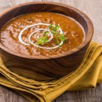 Dal Makhani · Lentils slow cooked with kidney beans, tomatoes, and spices.