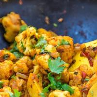 Aloo Gobi · Potatoes and cauliflower cooked with cumin seeds and various spices.