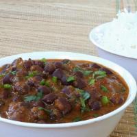 Kala Chana Curry · Black chickpeas slowly cooked with tomatoes, onions, and spices,