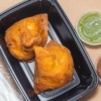 Veg Samosa (2 Pcs) · Fried pastry filled with vegetables and spices. Served with mint-coriander & tamarind chutney