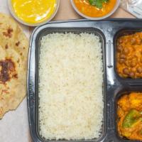 Gujarati Thali · A full meal comprising of Kala Chana, Dal, Toor Ringan, Rice, Roti, Kesar Srikhand, Pickle &...