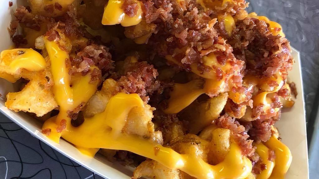 Loaded Curly Fries · Large curly fries with topped with bacon and melted cheese.