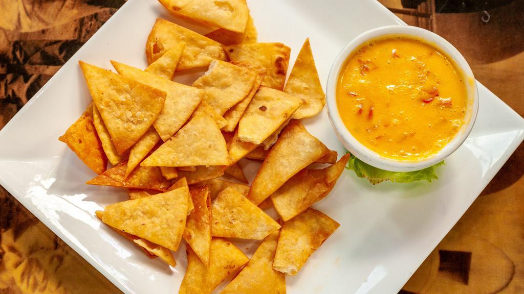 Cheese Dip · Golden velvet cheese with crispy flour tortilla chips.
