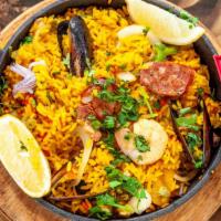 Mexican Seafood Paella · Spicy. Paella with grilled chicken, clams, shrimp, calamari and chorizo.