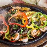Fajitas · All fajitas include sizzling platters of vegetables, Mexican rice, refried beans, guacamole,...