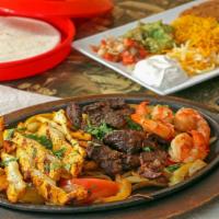Fajitas (Combination Three) · All fajitas include sizzling platters of vegetables, Mexican rice, refried beans, guacamole,...
