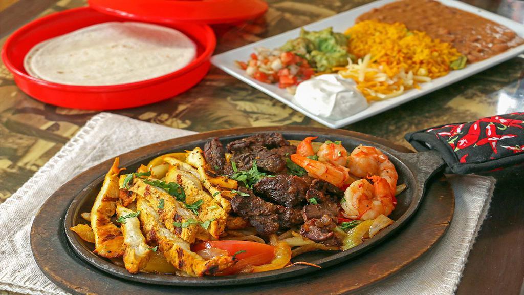 Fajitas (Combination Two) · All fajitas include sizzling platters of vegetables, Mexican rice, refried beans, guacamole, sour cream, pico de gallo shredded cheese and flour tortillas.