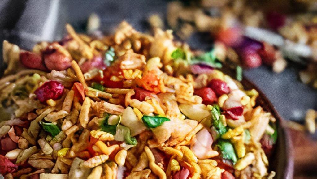 Bhel Puri · A snack with iconic status in Western India, Bhelpuri is low-fat, nutritious and delicious street food. Puffed rice, chick pea, chopped onions and cilantro tempered with trio sauces.
