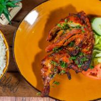 Tandoori Chicken · Half a chicken marinated in yoghurt, ginger and house spices then cooked in a clay oven.