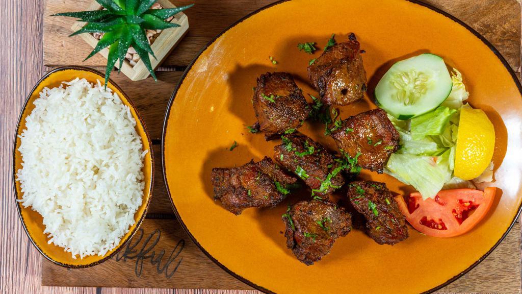 Lamb Seekh Kabab · Boneless lamb marinated with special blend of house spices then cooked in a clay oven.