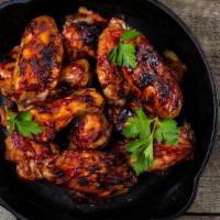Jerk Bbq Wings · Delicious, crispy wings tossed in a Jerk BBQ sauce and fried to perfection. Served with cele...
