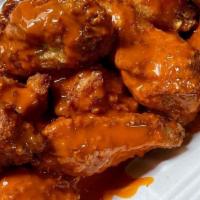 Buffalo Wings · Cooked wing of a chicken coated with hot or mild sauce, with blue cheese and celery.