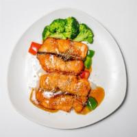 Salmon Teriyaki · Grilled salmon with teriyaki sauce and a bed of steamed veggies and sesame seeds.