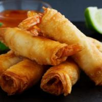 Ground Shrimp Spring Rolls · Delicious spring roll stuffed with ground shrimp, served on a bed of lettuce and cabbage wit...