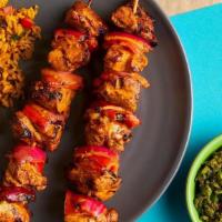 Chicken Thigh Skewers · Two skewers of skin-on-thighs, red pepper, and onions.