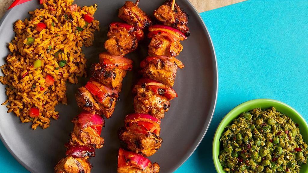 Chicken Thigh Skewers · Two skewers of skin-on-thighs, red pepper, and onions.