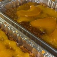 Peach Cobbler  · Peach Cobbler Loaded with Fresh Peaches Topped with Our Peach Sauce