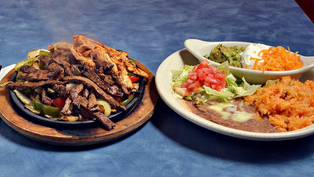 Fajitas · Choose between, shrimp, steak, or chicken. Served with rice, beans, warm tortillas, cheese, sour cream, and guacamole.