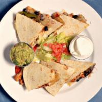 Grilled Quesadilla · Choice of charbroiled chicken strips, steak or shrimp with melted Jack cheese in a grilled f...