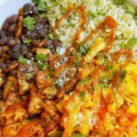 Mango Chicken Bowl* · Grilled lime chicken, mango salsa, spinach, cilantro rice, black beans, cilantro, cotija, ma...
