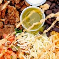 Ancho Steak Bowl* · Your choice bowl served with Grilled ancho steak, mexican rice, black beans, lettuce, pico d...