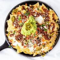 Loaded Nachos* · Season house chips topped with  ground beef, jalapenos, sour cream, guacamole, queso, refrie...