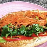 Braised Steak Banh Mi · Caramelized onion spread, cucumbers, cilantro, pickled carrots, pickled red chiles.