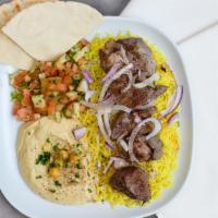 Lambo Bowl · Skewered pieces of lamb marinated in a blend of herbs and spices served with yellow rice and...