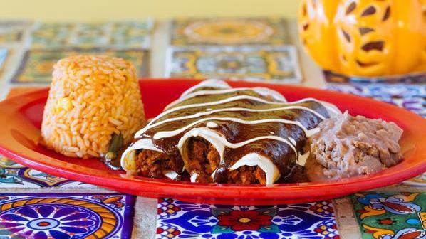 Tinga Enchiladas · Three soft corn tortillas topped with cheese sour cream and the sauce of your choice. served with rice and beans.