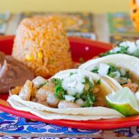 Shrimp Tacos · Three shrimp tacos topped with onions and cilantro. Serve with rice and beans and your choic...