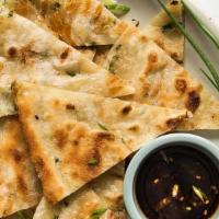 Scallion Pancakes · Delicious flat, fried disks of dough brushed with sesame oil and sprinkled with scallions.