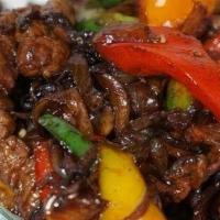 Bangkok Beef · Spicy slices of tender beef fused with onions, mushrooms, bell peppers and drenched in a zip...