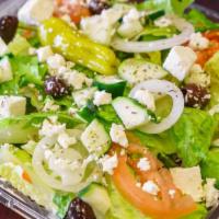 Greek Salad · A crisp bed of lettuce with feta cheese, sliced red ripe tomatoes, onions, cucumbers, olives...